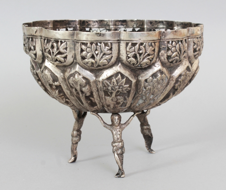 A SOUTH-EAST ASIAN EMBOSSED SILVER-METAL BOWL, weighing 285gm, supported on three figural feet,