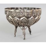 A SOUTH-EAST ASIAN EMBOSSED SILVER-METAL BOWL, weighing 285gm, supported on three figural feet,