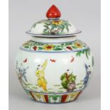 A CHINESE DOUCAI PORCELAIN JAR & COVER, the sides decorated with a continuous scene of boys