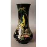 A 19TH CENTURY CHINESE FAMILLE NOIRE PORCELAIN VASE, of unusual form, the sides painted with a