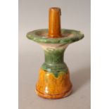 A CHINESE MING DYNASTY POTTERY JOSS STICK HOLDER, applied with green and ochre glazes, 5.7in high.