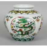 A CHINESE DOUCAI PORCELAIN JAR, the sides decorated with repeated dragon roundels, the base with a