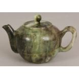 A CHINESE JADE LIKE HARDSTONE TEAPOT & COVER, the predominantly green stone with lighter and