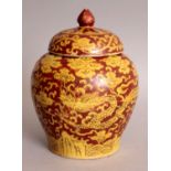 A GOOD CHINESE MING STYLE RED GROUND PORCELAIN JAR & COVER, decorated in yellow with two dragons