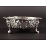 A VICTORIAN CIRCULAR SUGAR BASIN with floral repousse decoration, on three claw feet. 5ins diameter.