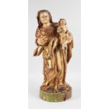 A 17TH-18TH CENTURY POLYCHROME MADONNA AND CHILD, CARVED WOOD ON A CIRCULAR BASE. 23ins high.