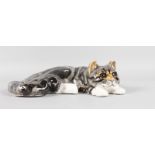 A RECLINING POTTERY CAT by WINSTANLEY. Signed. No. 6. 13ins.