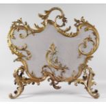 A GOOD LARGE 19TH CENTURY FRENCH ORMOLU STANDING FIRE GUARD, in a scrolled acanthus frame with