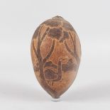 AN AUSTRALIAN ABORIGINAL DECORATED SEED POD with emu and trees. 16cms long.
