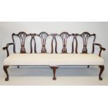 A LARGE CHIPPENDALE DESIGN MAHOGANY FOUR CHAIR BACK SETTLE, with pierced rails, serpentine top, long