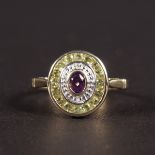 A 9CT YELLOW GOLD ART DECO DESIGN AMETHYST, DIAMOND AND PERIDOT RING.