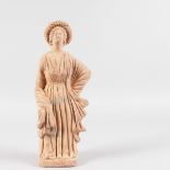 AN EARLY TERRACOTTA FIGURE OF A YOUNG WOMAN. 12ins high.