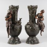 A GOOD PAIR OF 19TH CENTURY FRENCH BRONZED VASES with applied young man and woman sitting on the