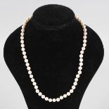 A STRING OF PEARLS with gold clasp.