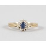 A BRILLIANT AND BLUE STONE OVAL 9CT YELLOW GOLD RING.