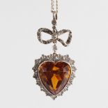A SILVER HEART SHAPED PENDANT AND CHAIN.