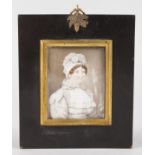 A VICTORIAN MINIATURE OF A LADY in a white bonnet. 2.5ins x 2ins.