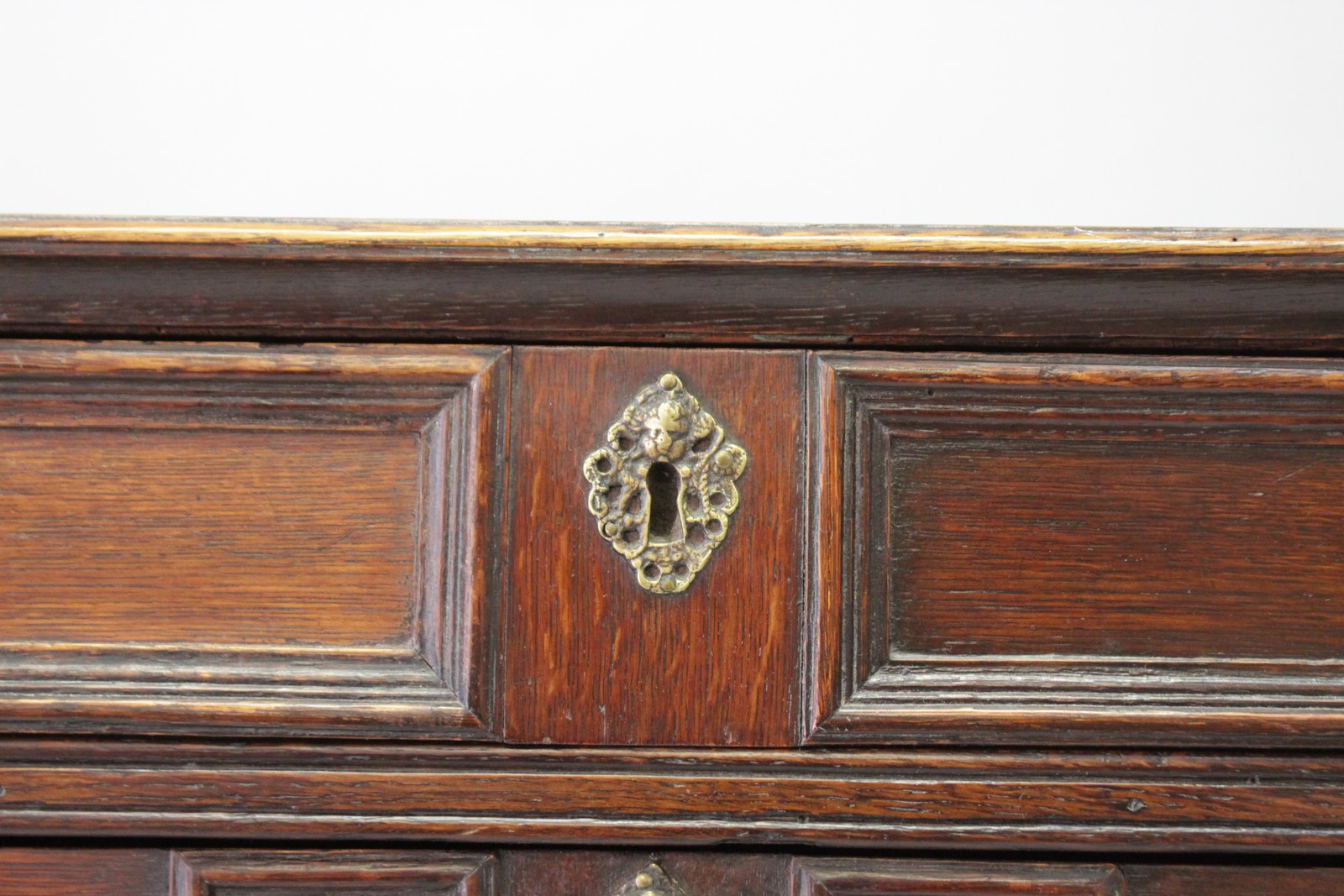 A 17TH CENTURY OAK CHEST OF DRAWERS, in two parts, with four long drawers, brass drop handles on - Image 2 of 3
