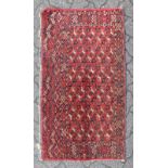 AN AFGHAN WALL HANGING, red ground with repeat pattern, within double borders. 2ft 3ins x 3ft 7ins.