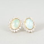 A PAIR OF OPAL AND DIAMOND OVAL CLUSTER EARRINGS, APPROX. 3CTS, set in 18ct yellow gold.