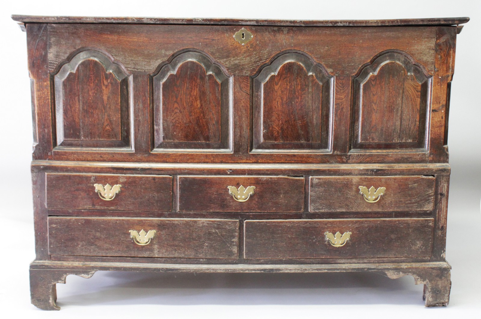 AN 18TH CENTURY OAK MARRIAGE CHEST, with rising top over four arched fielded panels, five drawers,