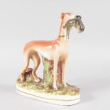 A STAFFORDSHIRE GREYHOUND with hare in its mouth. 11.5ins high.