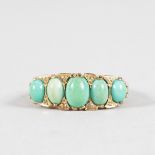 A FIVE STONE TURQUOISE HALF HOOP 9CT YELLOW GOLD RING.