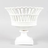 A FRENCH WHITE PORCELAIN PIERCED PEDESTAL BASKET on a square base. 8.5ins high.