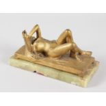 RAPHAELL A GILT BRONZE LAYING NUDE with long flowing hair on a bed, on onyx. Signed SUZ. RAPHAELL.