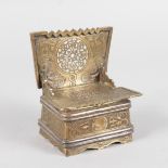 A RUSSIAN ENGRAVED AND PIERCED BOX SETTLE with lift up lid, the lid with calligraphy. 7cms wide, 8.