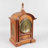 A 19TH CENTURY GOTHIC STYLE OAK BRACKET CLOCK by J. TRUSCOTT, ABERYSTWYTH, with circular brass dial,