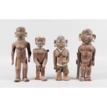 A SET OF FOUR ETHNIC CARVED WOOD TRIBAL FIGURES, some with original beadwork, 11ins high (2) and