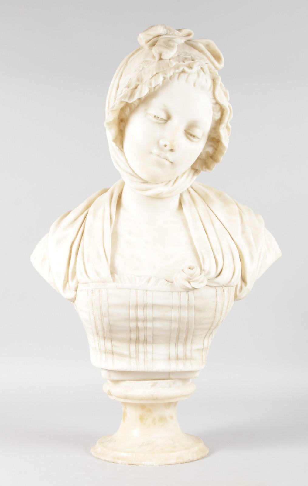 A SUPERB QUALITY 19TH CENTURY FRENCH CARVED WHITE MARBLE BUST OF A YOUNG GIRL, wearing a bonnet,