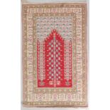 A SMALL PERSIAN PART SILK PRAYER RUG, with flowers and other motifs. 3ft 8ins long, 2ft 3ins wide.