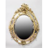A GOOD LARGE 19TH CENTURY FRENCH OVAL GILTWOOD MIRROR in a frame, decorated with leaves and flowers.