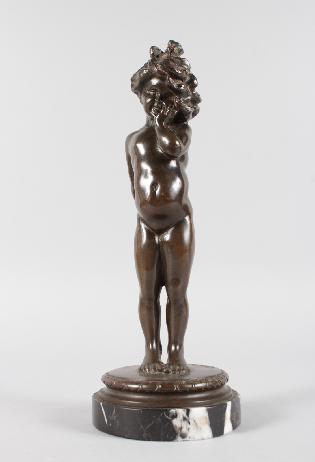 KLINKENBERG A BRONZE OF A YOUNG STANDING NUDE GIRL. Signed, on a marble base. 11ins high.