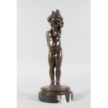 KLINKENBERG A BRONZE OF A YOUNG STANDING NUDE GIRL. Signed, on a marble base. 11ins high.