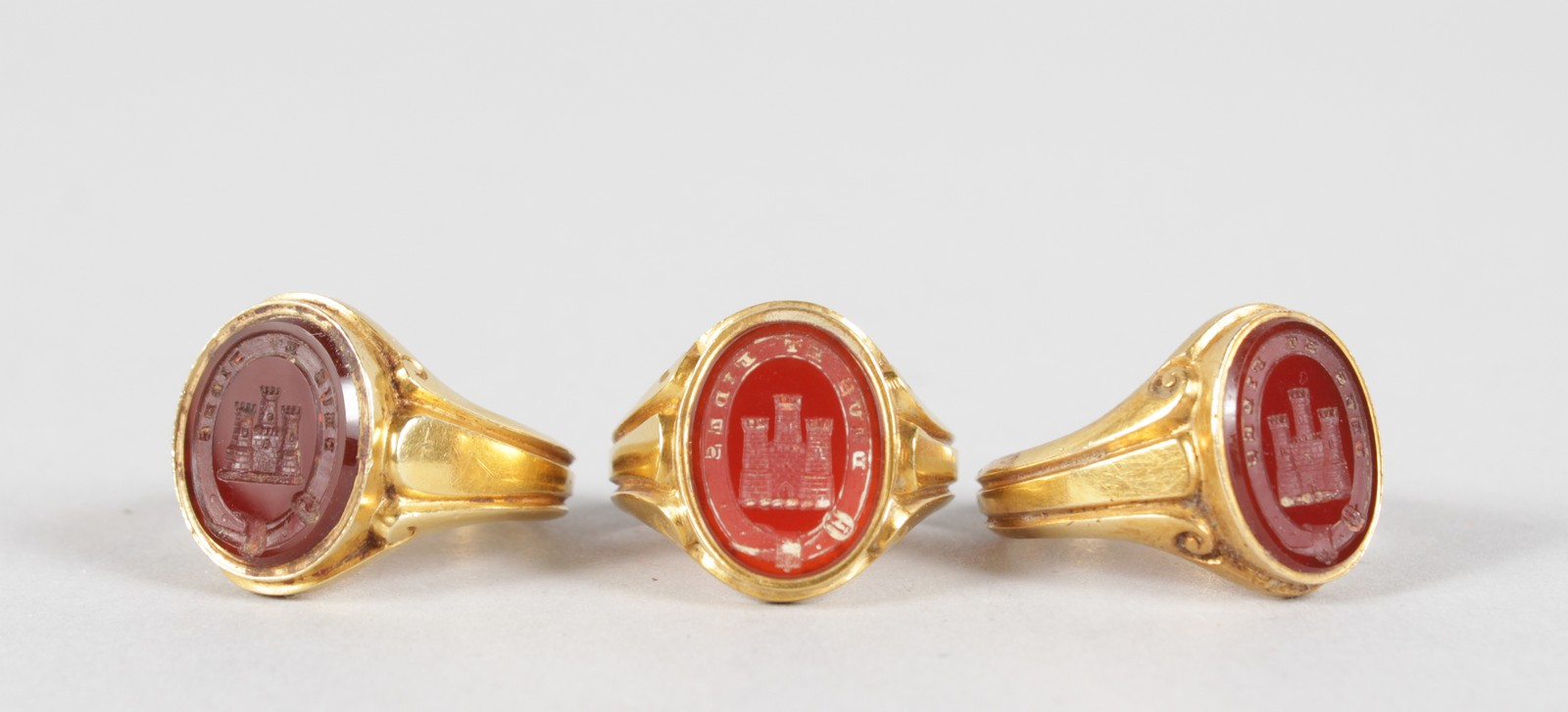 THREE 18CT YELLOW GOLD SEAL RINGS, a three turret castle.