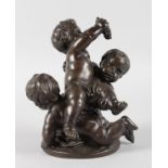 A LOVELY SMALL 19TH CENTURY FRENCH BRONZE OF THREE PLAYFUL CHERUBS, one holding a bunch of grapes,