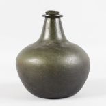 A JAMES II "SACK" ONION SHAPED DARK GREEN BOTTLE. 7.5ins high, 7ins diameter. See label on