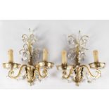 A PAIR OF 1920'S FRENCH GILT METAL TWO LIGHT WALL LIGHTS, hung and inset with crystals. 15ins long.