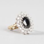 A BLACK STONE AND BRILLIANT SET 9CT YELLOW GOLD DRESS RING.