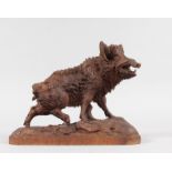 A WELL CARVED 19TH CENTURY BLACK FOREST MODEL OF A BOAR on a rustic base. 9.5ins long, 7.5ins high.