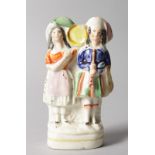 A SMALL STAFFORDSHIRE FLAT BACK GROUP, "BOY AND GIRL". 5ins high.