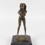 AFTER BRUNO ZACH A BRONZE SEMI CLAD STANDING GIRL leaning forward, on a square marble base. 12ins
