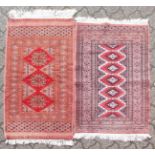 A PERSIAN DOUBLE BORDER RUG, salmon ground, 3ft 2ins x 2ft; together with a similar example. 2ft
