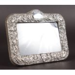 A RECTANGULAR PHOTOGRAPH FRAME with repousse decoration. 5.5ins x 6.5ins.
