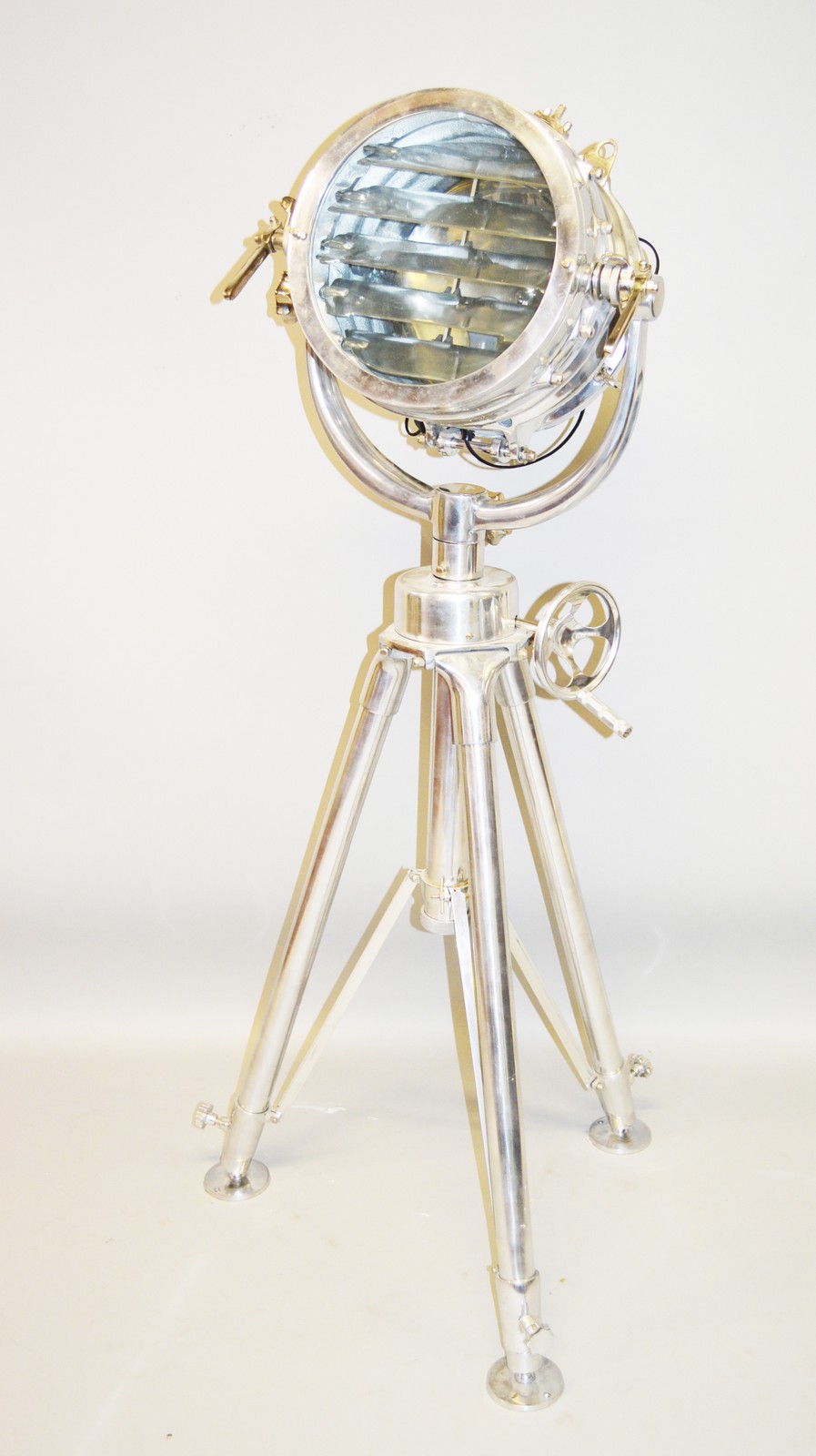 A LARGE CHROME FILM SEARCH LIGHT on a tripod stand. 5ft high. Provenance: From a flat in Clapham.