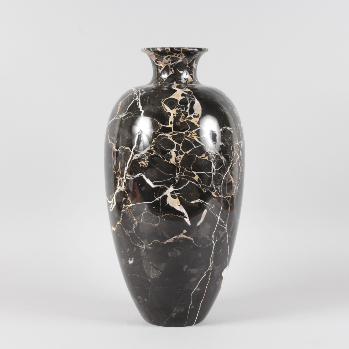 A LARGE BLACK AND GOLD MARBLE VASE. 17ins high.