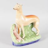 A STAFFORDSHIRE GREYHOUND, rabbit at its feet. 10ins high.